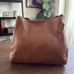 Handbag by Coach, color- brown, condition - good